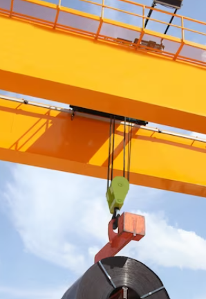 overhead yellow crane lifting outside